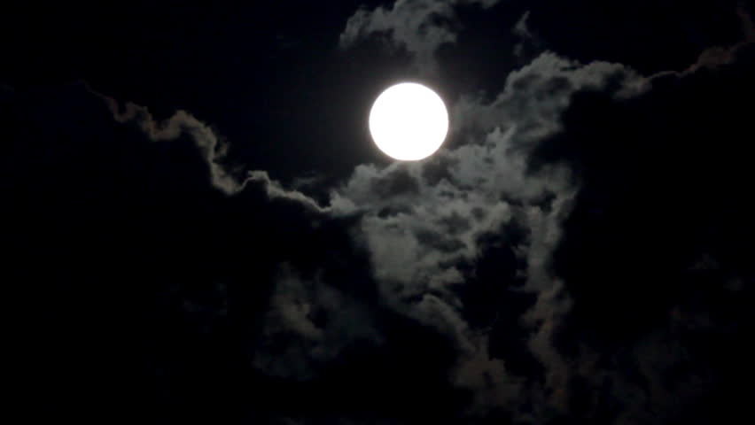 timelapse with moon moving between clouds