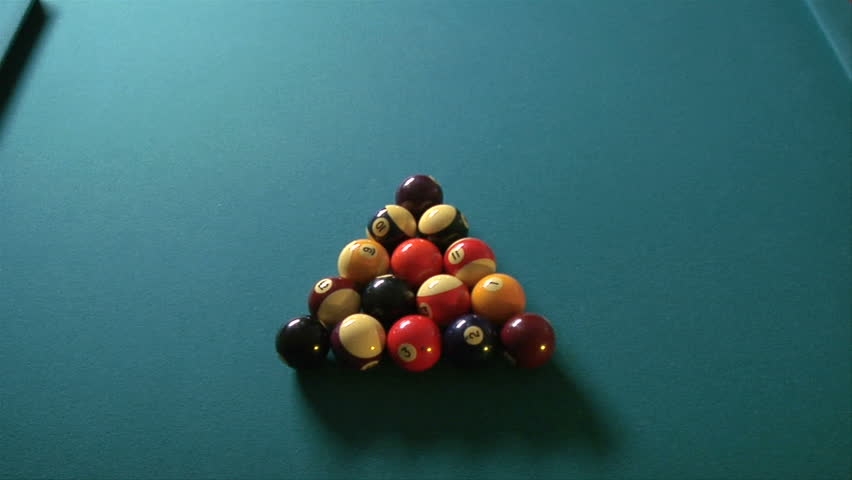 This is an overhead shot of billiards balls breaking.  This was shot with a fish-eye lens.