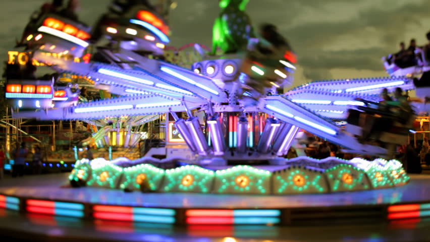 an amusement ride at a carnival or fair in barcelona spain, slightly blurred version