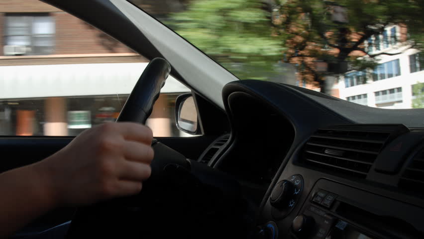 Steering car through city traffic time lapse