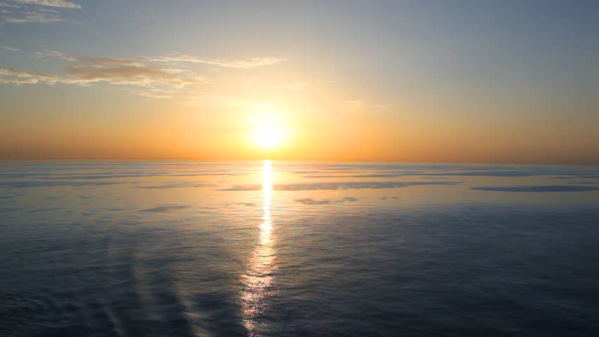 sunset on waving sea, view from top deck of moving cruiser