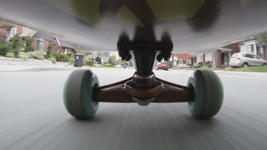 Riding a skateboard down an urban street. Toronto, Ontario, Canada. 