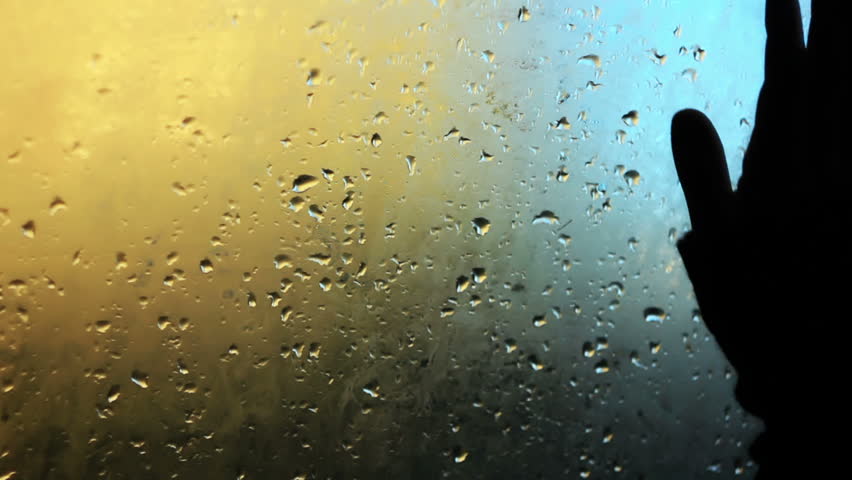 Hand wipes misted car window after the autumn rain.