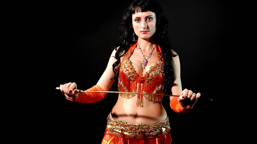 woman dancing in traditional arabic costume with sabre