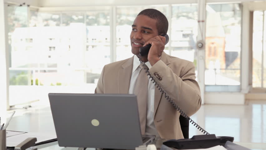 Businessman Using a Phone at the Office