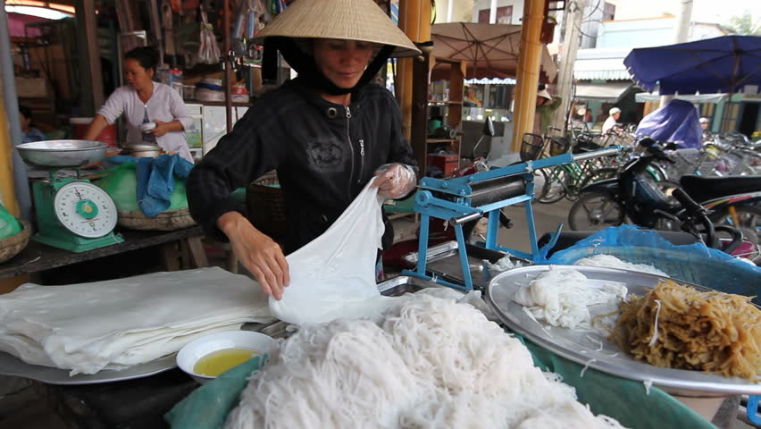 HOI AN, VIETNAM-FEBRUARY 28: A local woman makes rice noodles by hand on February 28, 2010 in Hoi An, Vietnam, a UNESCO world Heritage Site for the preservation of ancient traditions and buildings. 