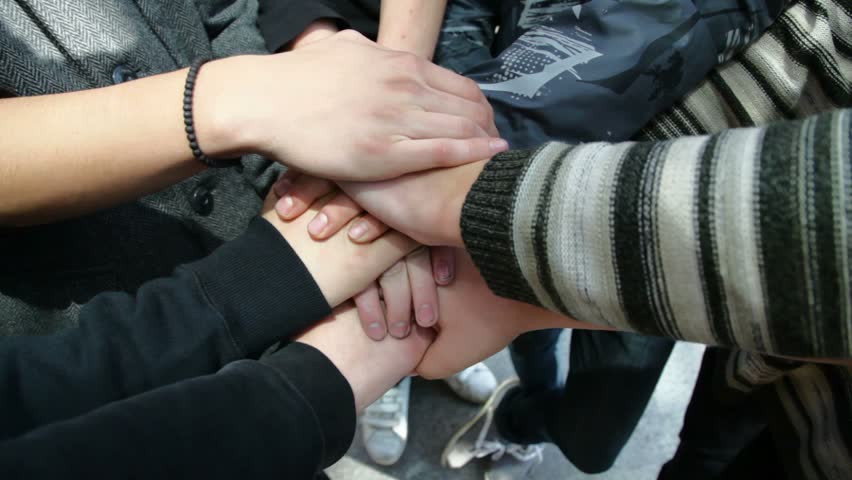 young male hands folded on one another showing friendship