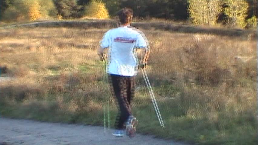 Man runs down hill on sunset two, tripod, 16x9