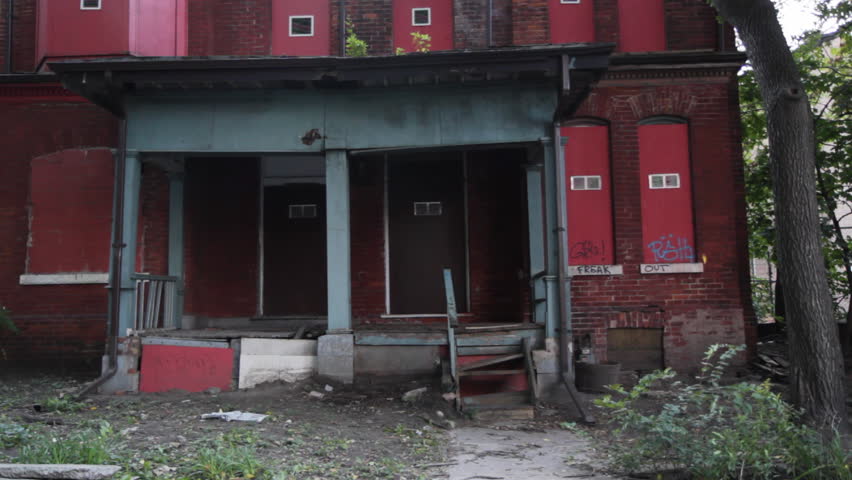 Abandoned house. Porch. Porch of condemned house. Boarded up and ready to be demolished. Toronto, Ontario, Canada. 
