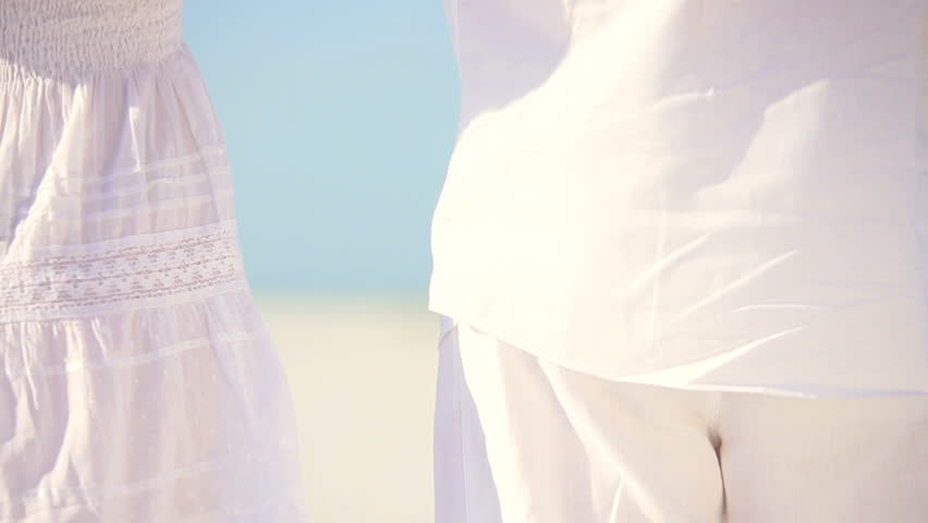 Attractive healthy couple enjoying quiet time together walking on the beach