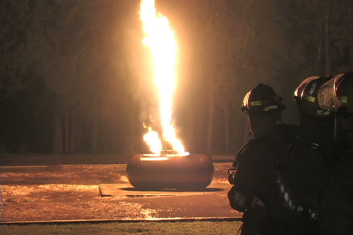 Closeup of firefighters battling a liquid propane tank fire