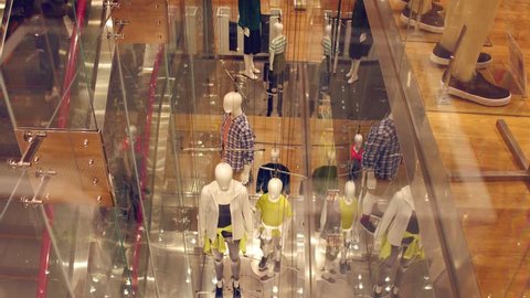 View through window to modern concept manikins at the store. Government manipulation concept.