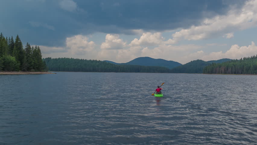 Aerial Flight Over Lonely Man On Canoe At Beautiful Lake Isolation Nature Vacation Difficulty