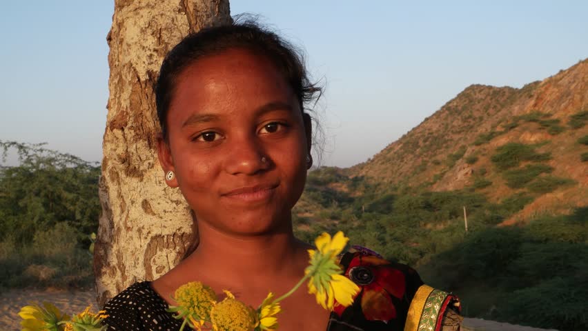 Indian Teenager Beautiful Girl With Flowers Yellow Waiting At A Hill Top Under A Tree On A Summer Day In Love Happy Joy Sun Tropical Hot Bright Sunshine Indian Teenager Beautiful Girl With Flowers Yellow Waiting At A Hill Top Under A Tree On A Summer Day In Love Happy Joy Sun Tropical Hot Bright Sunshine