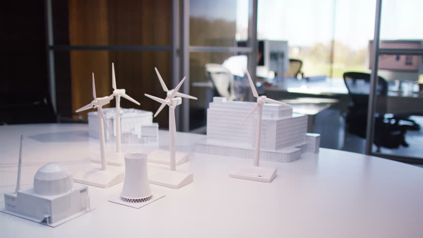 concept models of buildings and wind turbines on a desk in empty architects or engineers - Office Models Photos concept models of buildings and wind turbines on a desk in empty architects or engineers - Office Models Photos
