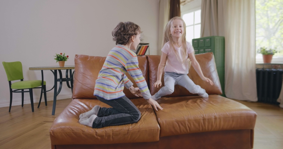 4k00 20happy Little Boy And Girl Jump On Couch Playful Kids Have Fun