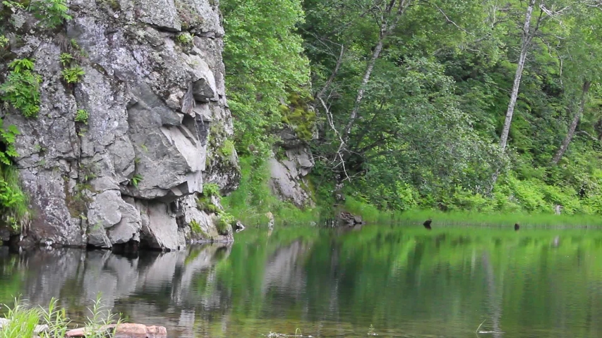 Rocks out into the lake under clouds image - Free stock photo - Public ...