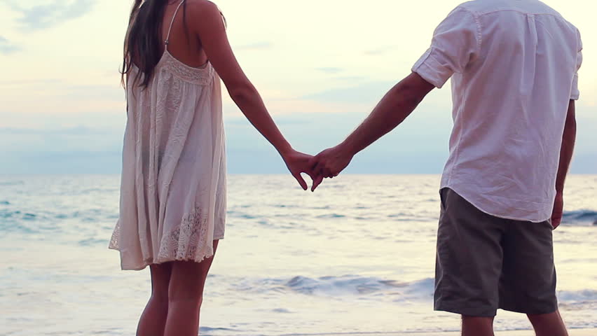 Newly Married Couple On Tropical Beach After Sunset Wedding - 852x480 - jpeg Holding Hands Beach Wedding