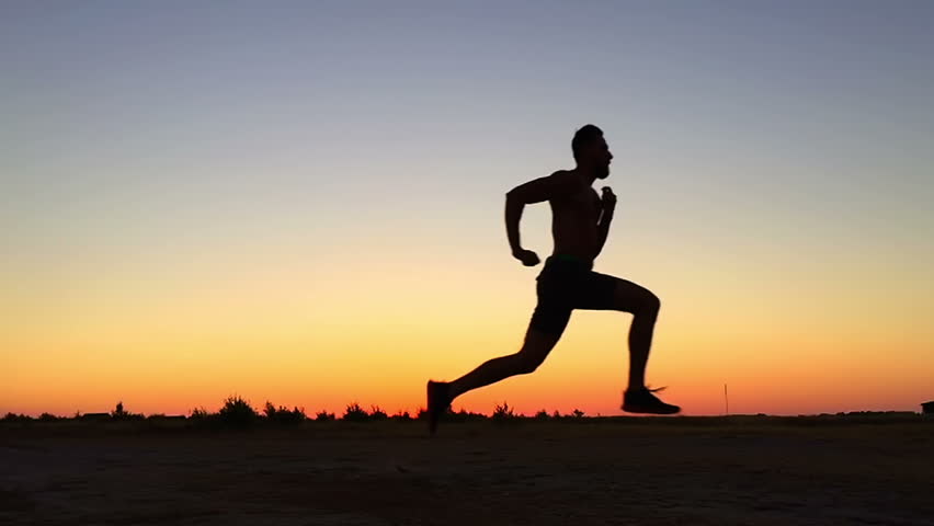 Jogging Runner Man Running At Sunset. Male Jogger Training For Marathon ...