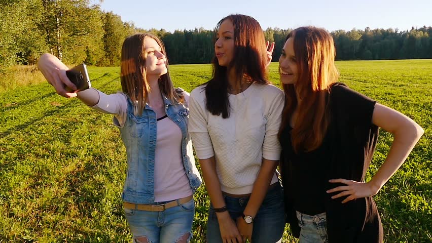 Five Teenage Girls Hug And Hold Up Peace Signs Stock