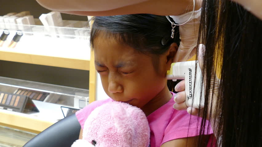 A Cute Little 9 Year Old Asian Girl Gets Her Ears Pierced For The Very