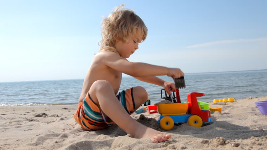 little child playing with toy truck and bulldozer on the beach hd stock video clip - Little Kid Pictures little child playing with toy truck and bulldozer on the beach hd stock video clip - Little Kid Pictures