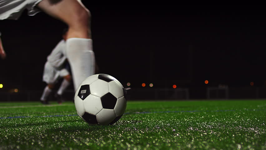 Female Soccer Players Pass The Ball During A Game At Night 