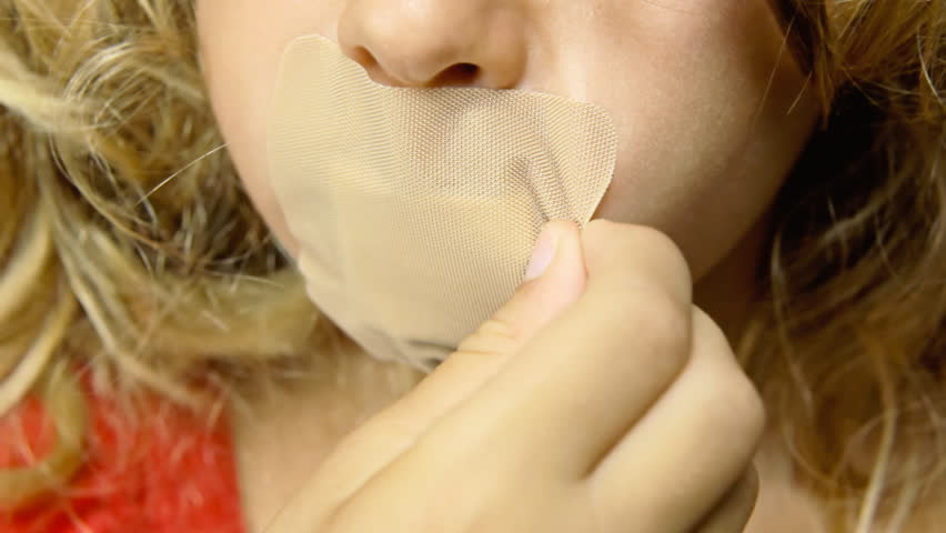 Tape girl. A girl with a Plaster on her mouth. A Asian girl with a Plaster on her mouth.