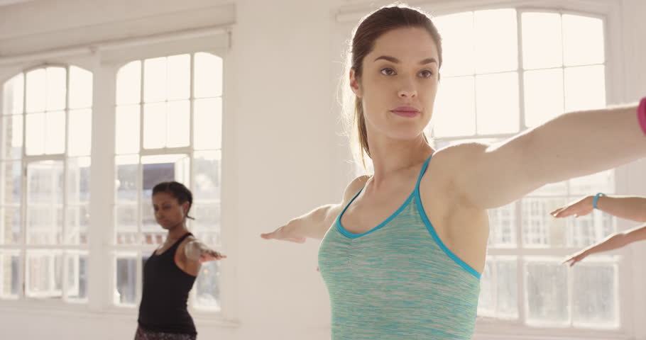 Yoga class multi racial group of women exercising healthy lifestyle in fitness studio yoga warrior poses