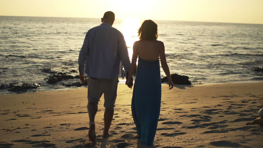 Couple Standing Hand In Hand On Beach At Sunset In Bali Stock Footage ...