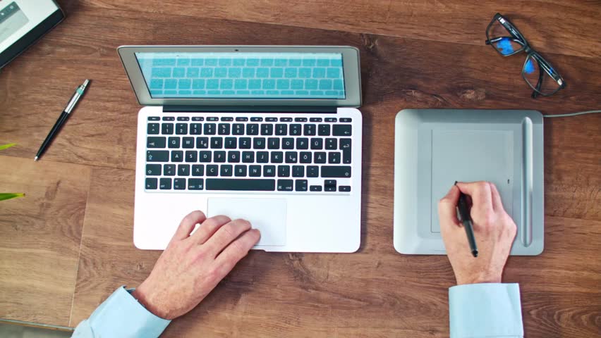 Businessman Working With Digital Drawing Stock Footage 100 Businessman Working With Digital Drawing Tablet And Pen On A Laptop Computer Wood Table Desktop Shot From Above Top View