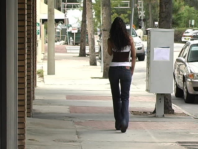 A Beautiful Latina Brunette Walking On A Sidewalk Talking On Her Cell Phone Stock Footage