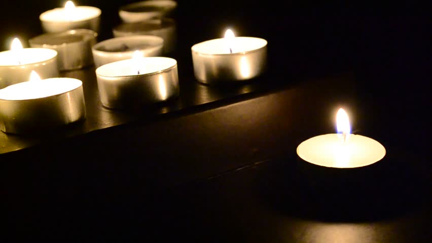 Five Flickering Candles On The Black Background. Stock Footage Video