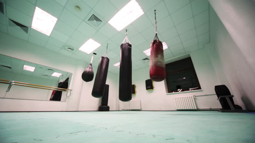 Four Different Size Punching Bag Hang In Boxing Training Room