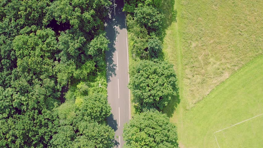 Aerial Shot Of A Car Driving Through A Forest Road Top View Stock ...