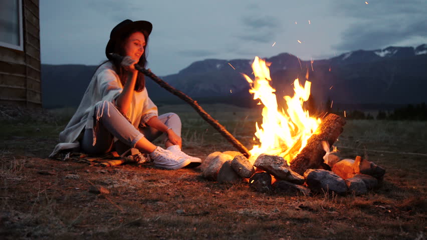Image result for person sitting by fire