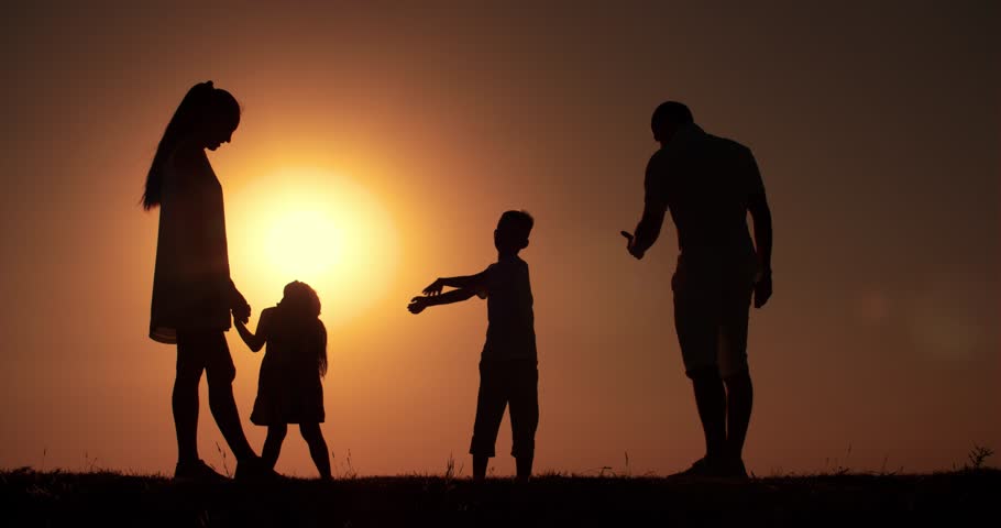 Silhouette Of Family Walking Together At Sunset Stock 