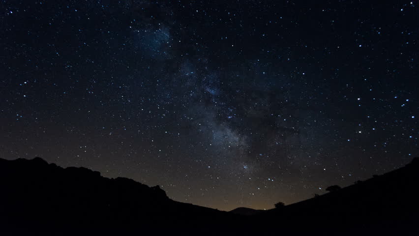 Night Time Lapse Stars Passing Over Mountains And Distant Ocean Stock ...