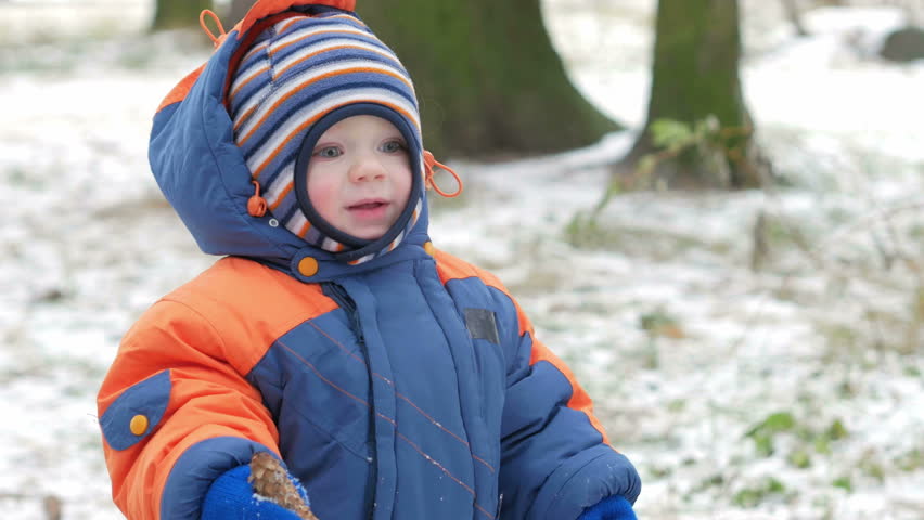 A Child Playing In The Park In The Snow. Portrait Of A Baby Boy Outside ...