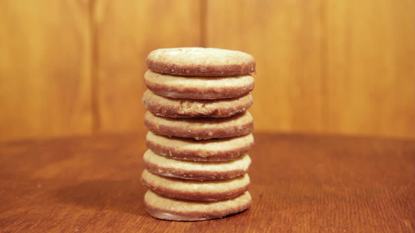 Tasty Glazed Cookies Rotating Slowly On The Background Wood Board Tasty Glazed Cookies Rotating Slowly On The Background Wood Board
