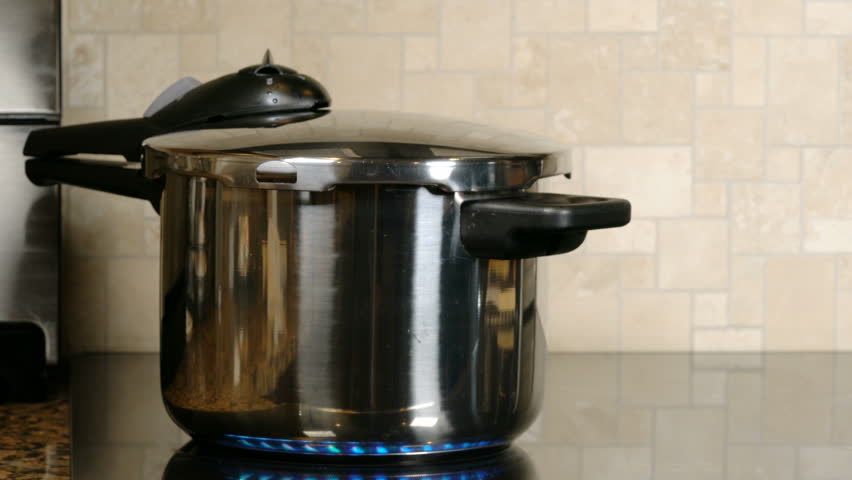 Stainless Steel Pressure Cooker Letting Stock Footage 100 Stainless Steel Pressure Cooker Letting Off Steam On A Modern Induction Cooking Hob With Glass Top