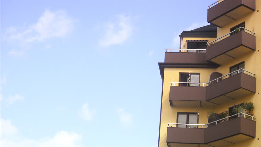 Wind Chime Mobile In Breeze Home Village Background Stock An Apartment Building Under Moving Clouds Hd Stock Footage Clip