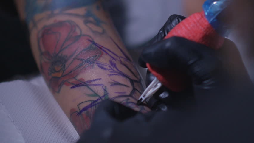 professional tattoo artist makes a tattoo on a young u0027s hand professional tattoo artist makes a tattoo on a young u0027s hand