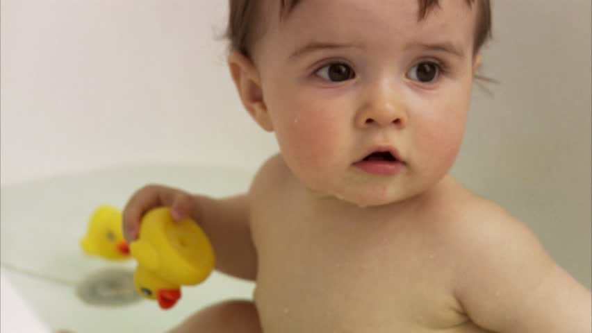 Infant Baby Girl Playing In A Bath With Water Stock Footage Video Child Sitting In A Bathtub Chewing Rubber Duck Hd Stock Video Clip