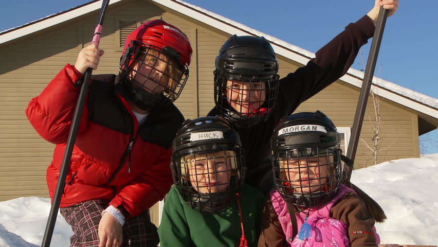 Hd00 20four Young Kids Pose In Hockey Gear On Backyard Ice Rink