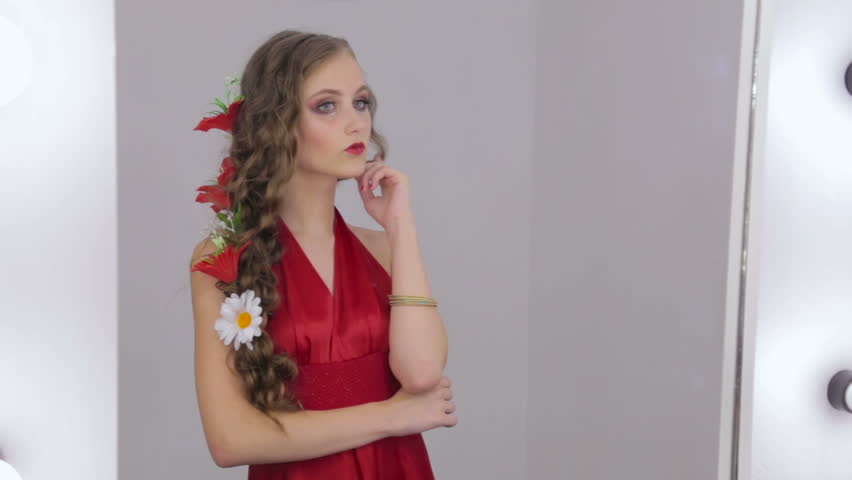 Beauty Teenage Girl In Red Dress Applying Make Up And Admiring Herself In The Mirror Beautiful