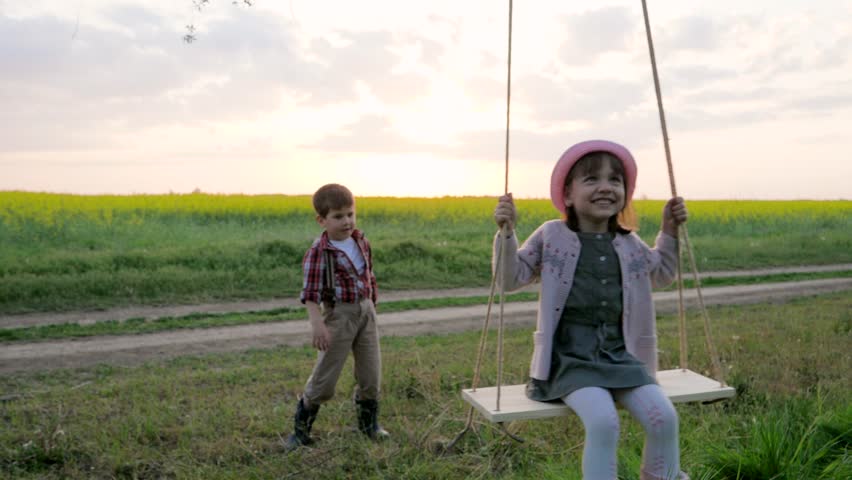 Two Kids Swinging On Swing Stock Footage Video 100 Royalty Free 27226873 Shutterstock