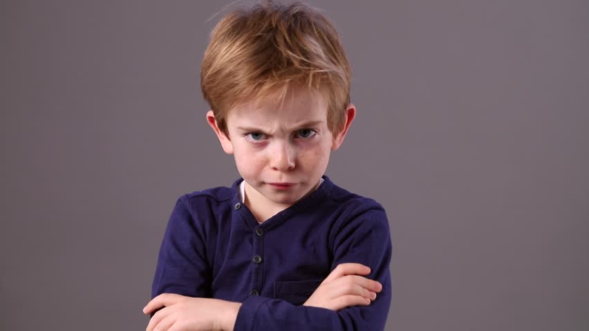 Cute 6-year Old Child With Red Hair Showing How To Look Mad, Angry ...