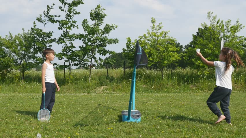 Boy Girl Playing Badminton In Yard Against House Wall Stockvideos 