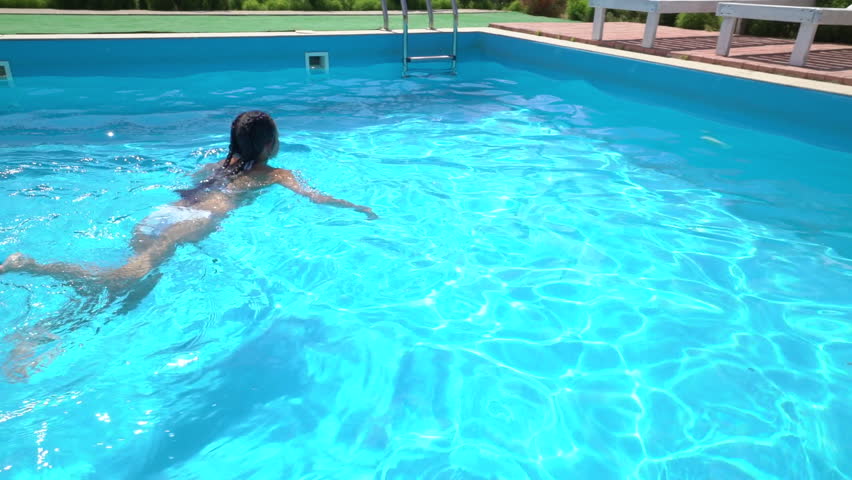 Young Girl In White Bikini With Inflatable Rubber Ring Swims picture